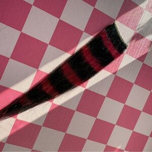 Pink and black raccoon tail hair extension